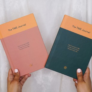 Pink and green TIME Journals held side by side